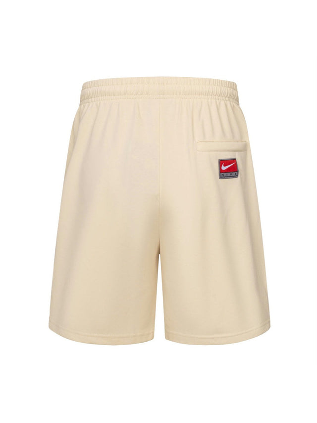 Short Nike crema con letras verdes