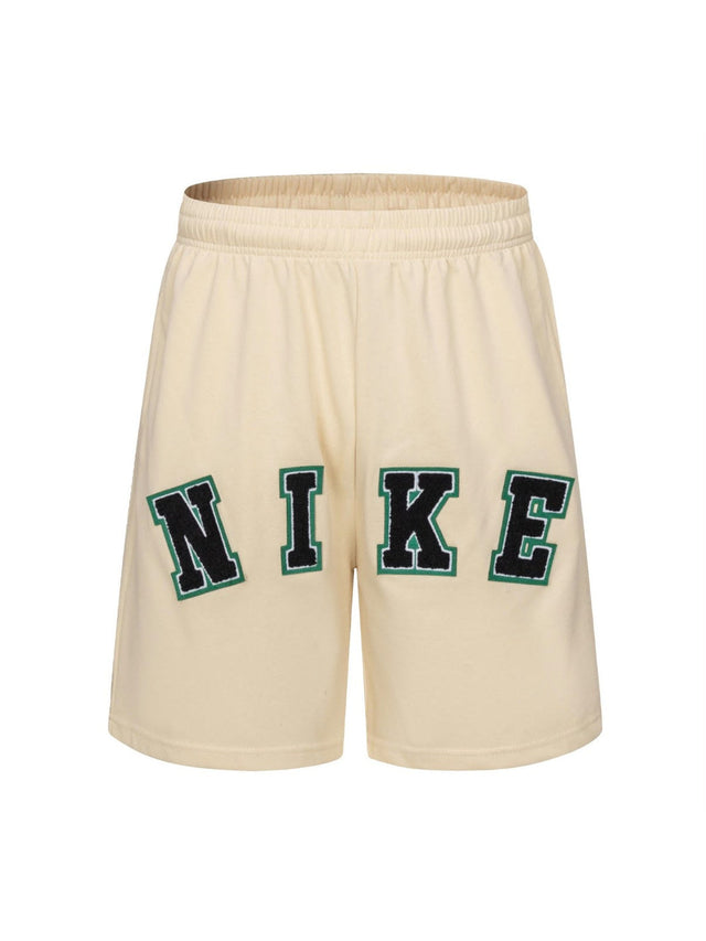 Short Nike crema con letras verdes